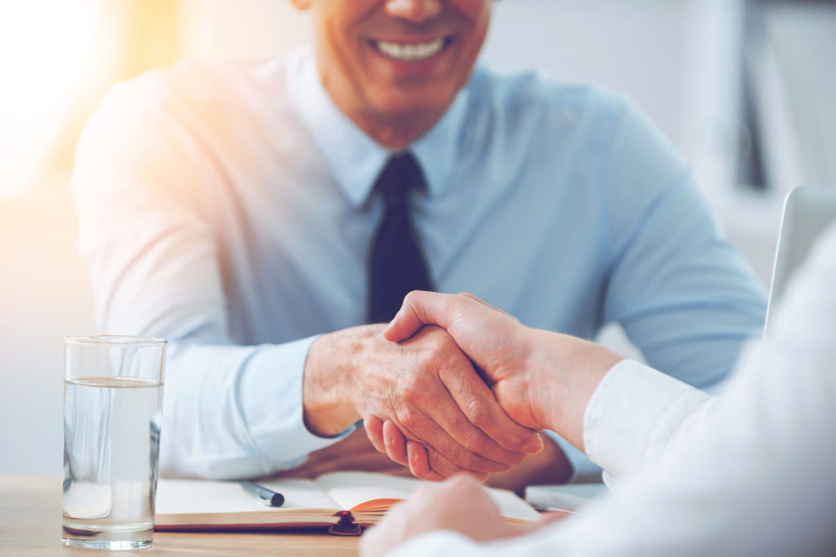 Two businessmen shaking hands representing a good landlord-tenant relationship