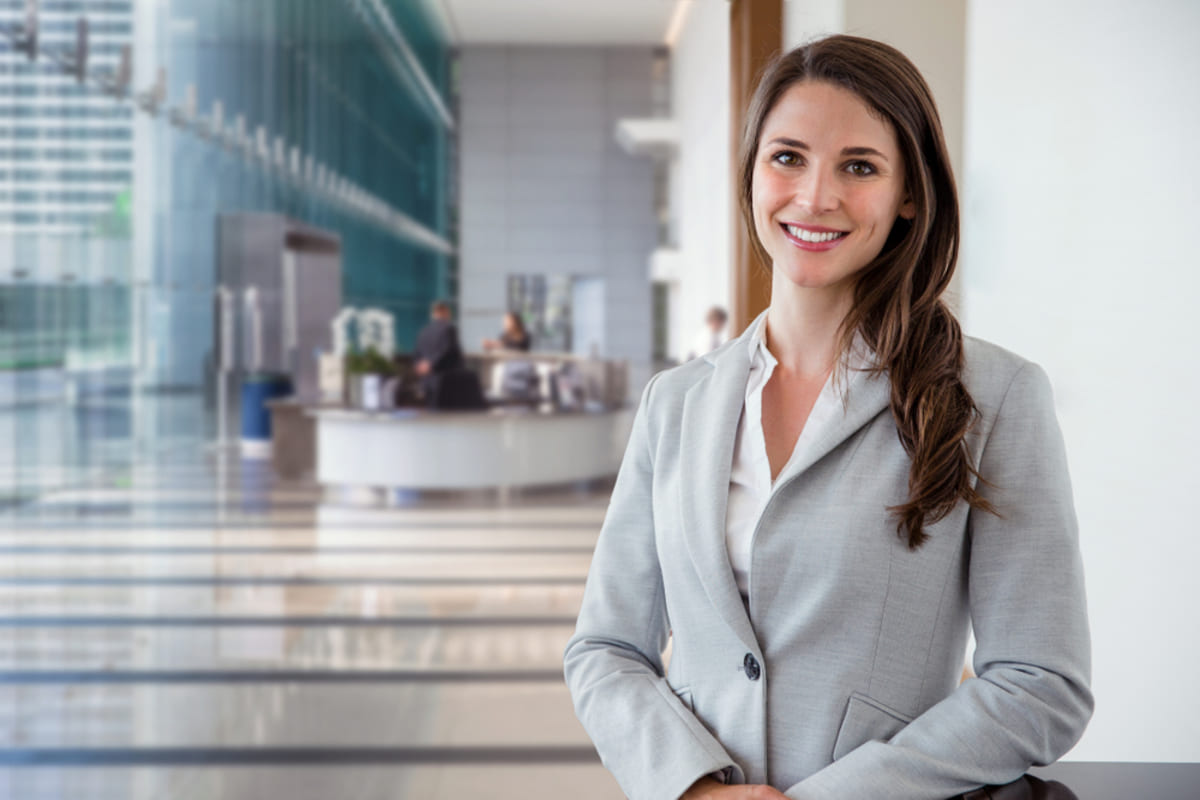 Woman in the lobby of a commercial building, commercial properties management concept