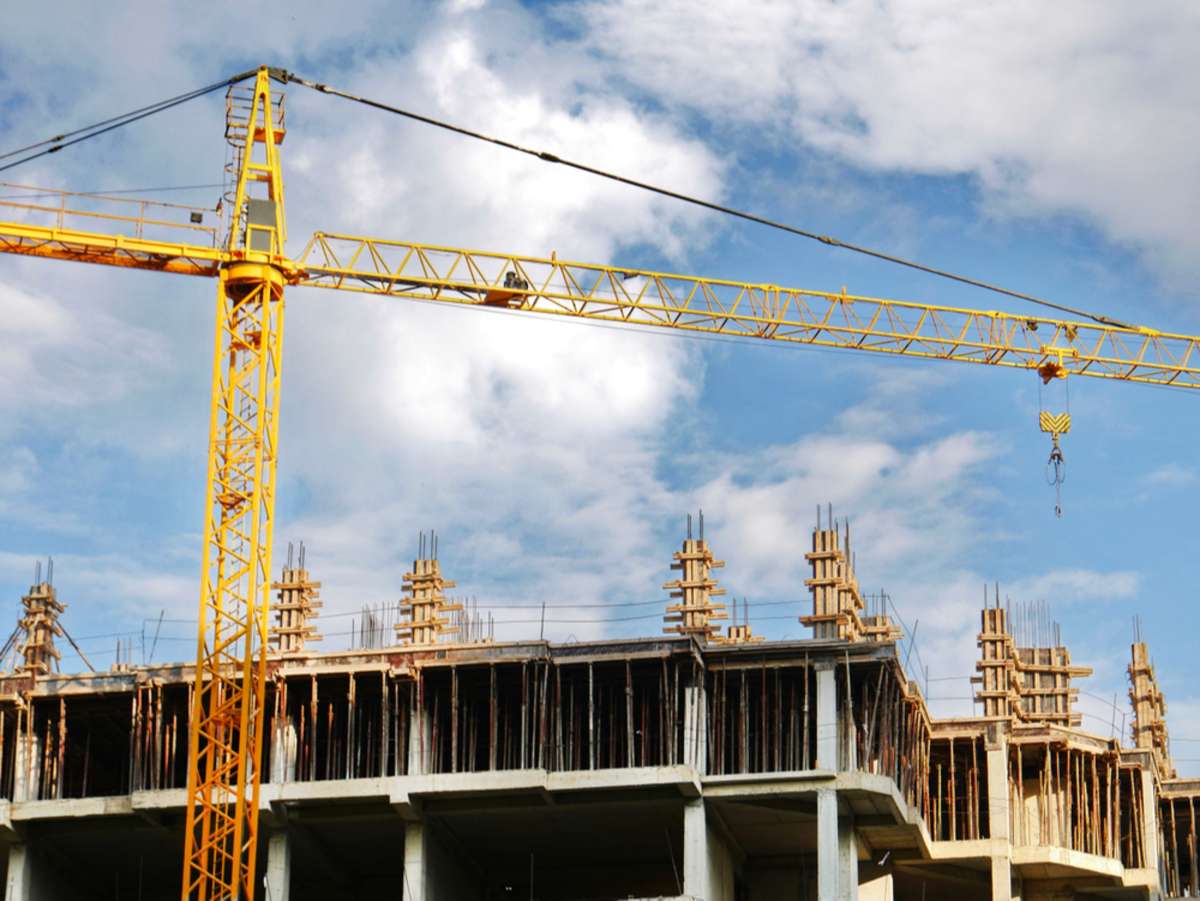 A crane next to a building under construction, real estate Chicago suburbs concept