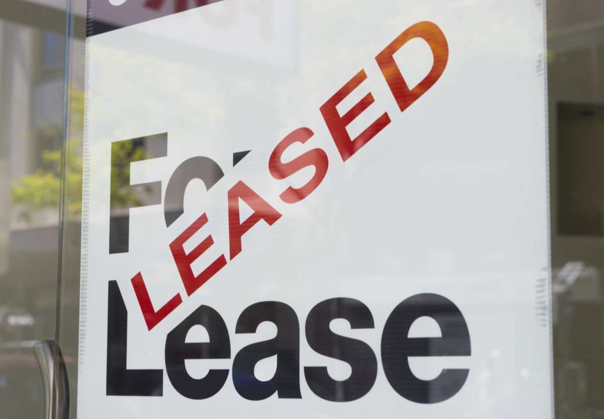 A leased sign in the window of a building, success with the real estate Chicago offers concept