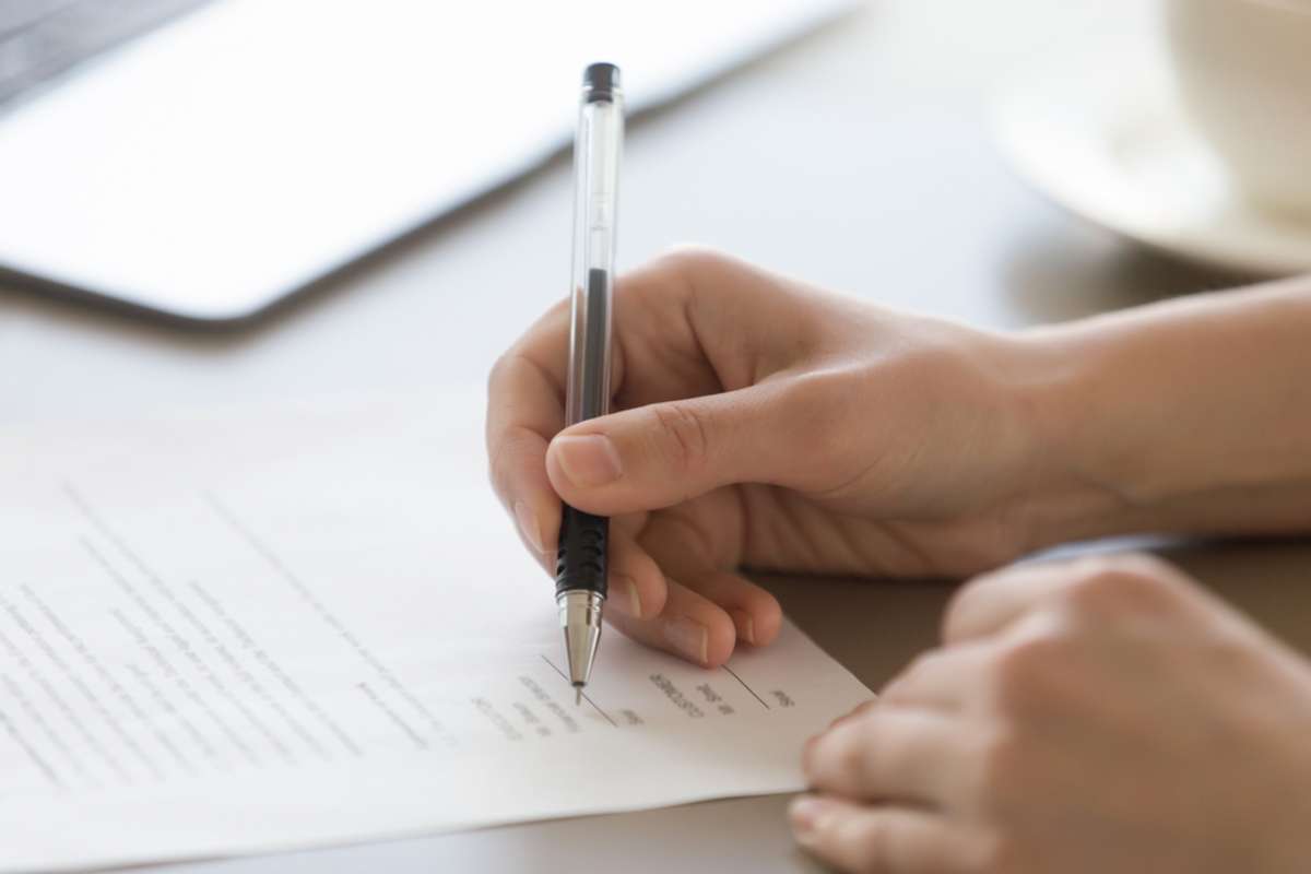 A person signs a commercial lease, property management Chicago concept