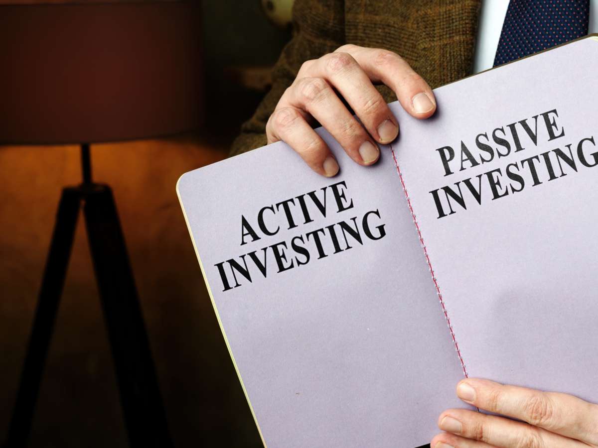 Active vs. passive investing on a notepad, commercial property investment opportunities concept