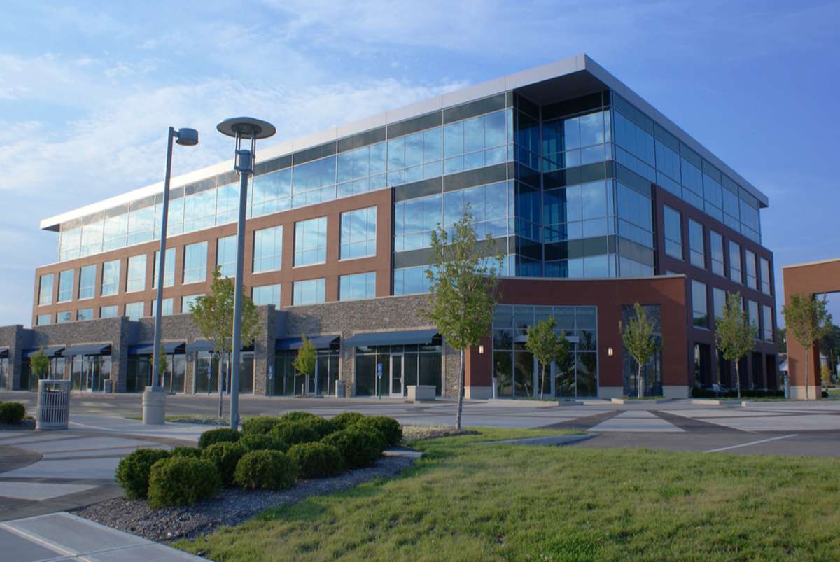 An exterior of a suburban office building, commercial real estate investing concept