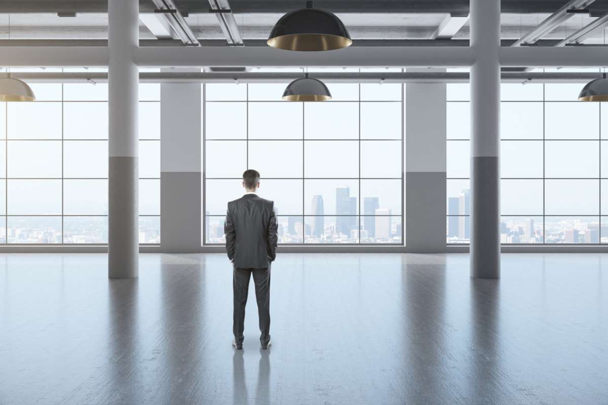 An investor stands in an empty office building, common for Chicagos commercial real estate market