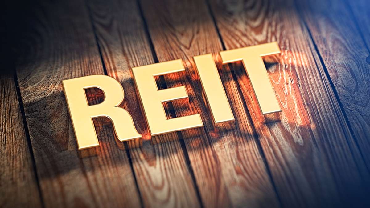REIT in gold letters, commercial real estate investment strategies concept