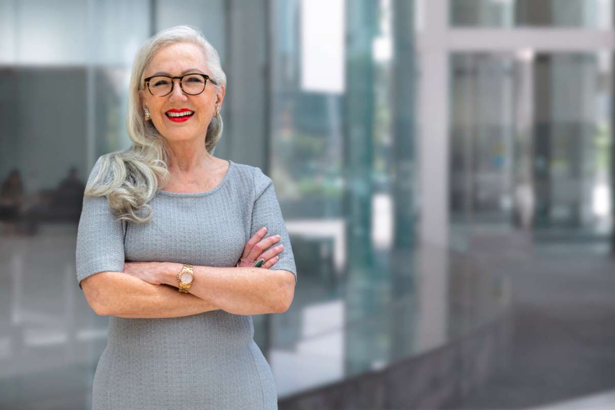 Smiling older businesswoman in a building, invest Chicago real estate concept