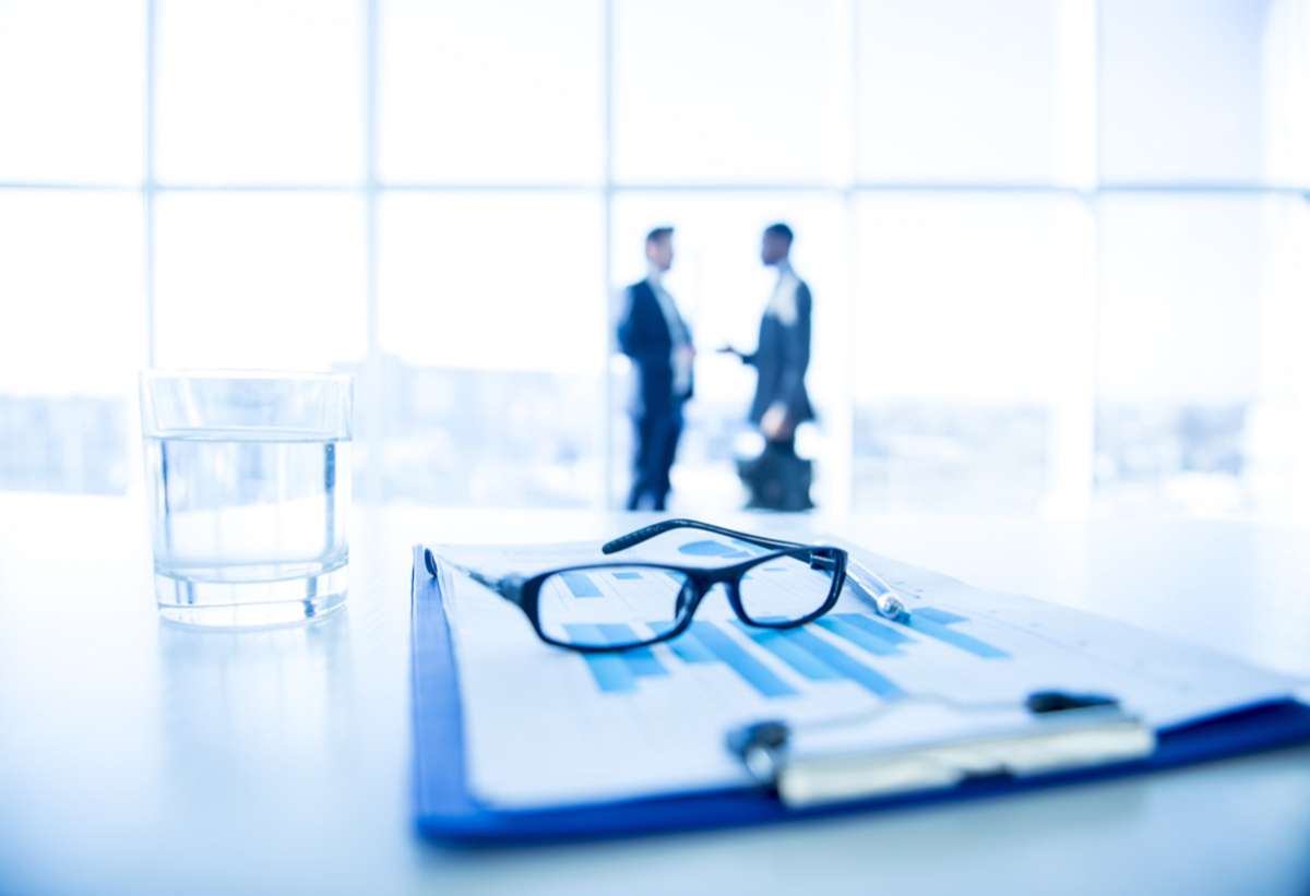 Two businessmen in the background of analysis on a table, property management Chicago concept