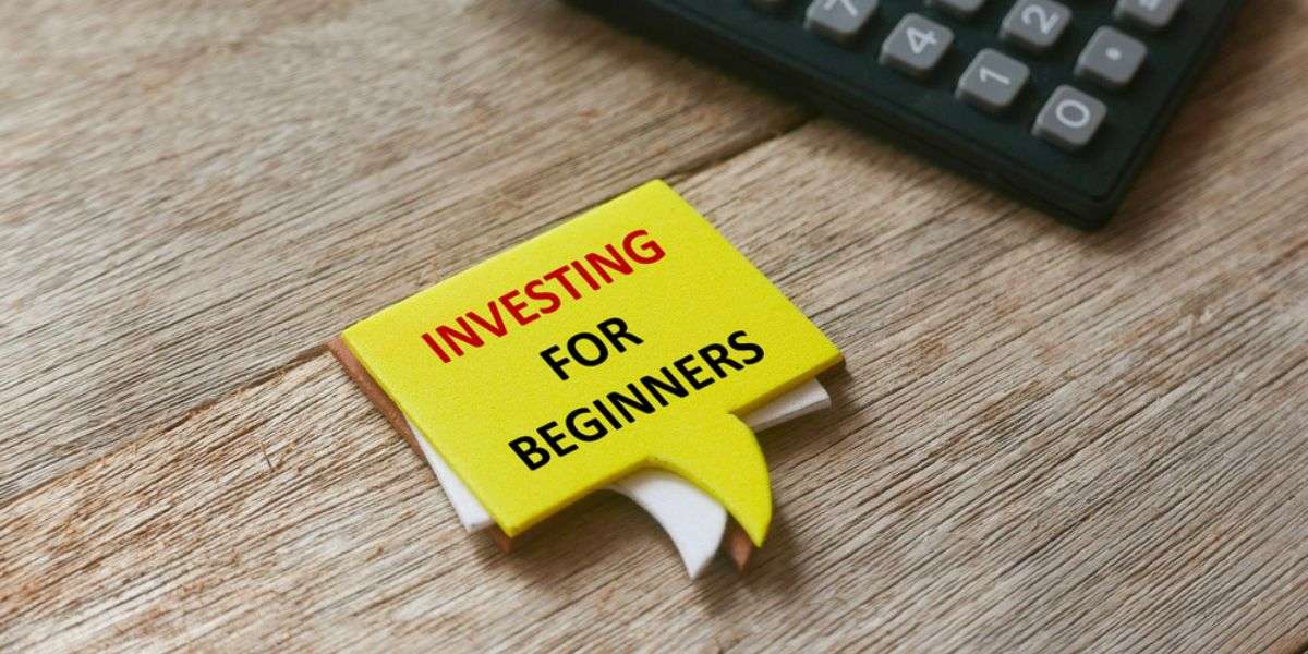 Selective focus of calculator and stack of speech bubbles written with Investing For Beginners on wooden background